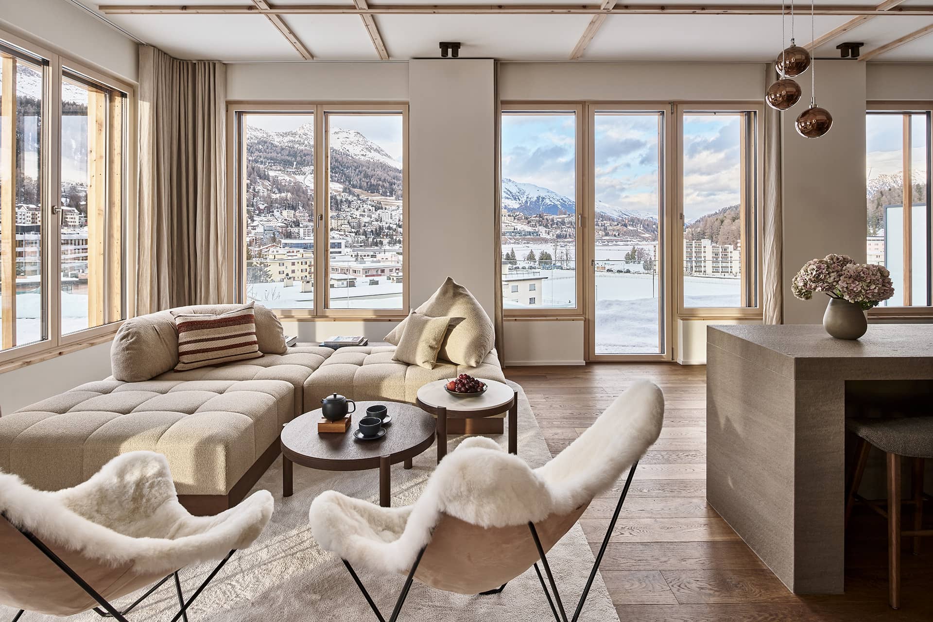 Großzügiger Wohnbereich mit bodentiefen Fenstern, Stadt- und Bergpanorama sowie offenem Grundriss.